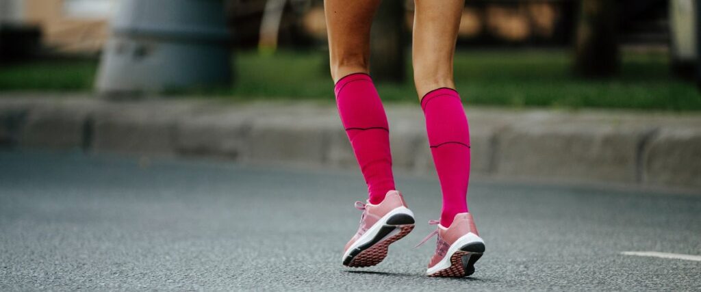 A woman runner wearing compression socks.