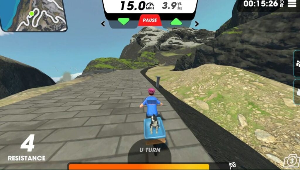 View of cycling avatar on the Hilltop Spiral route in Vingo going up a hill towards mountains. 