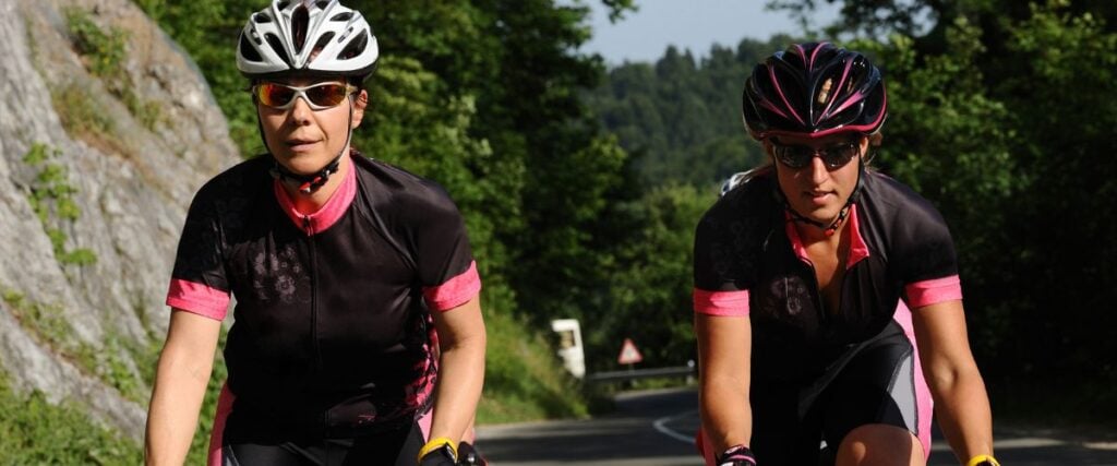 Two female cyclists looking forward to the road ahead. 