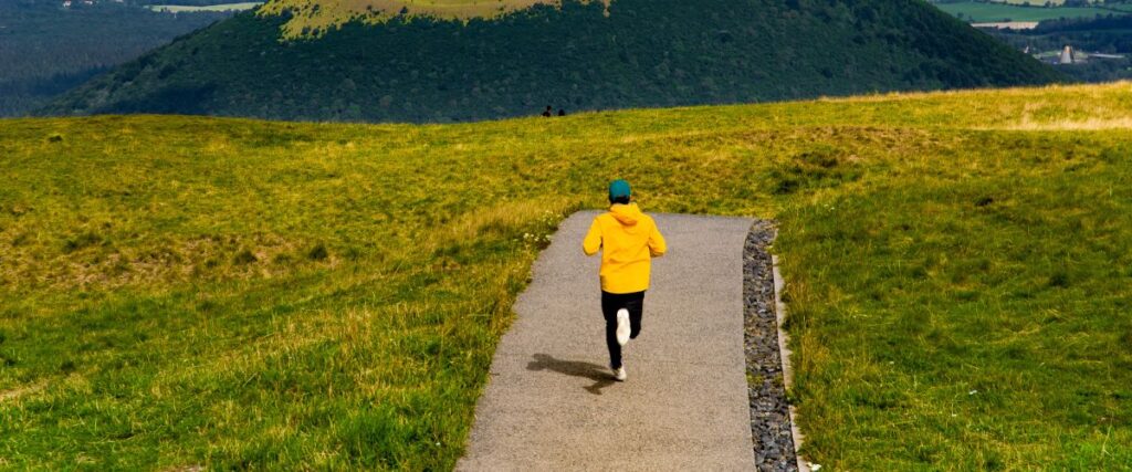 A runner on a gravel path in the mountains. 