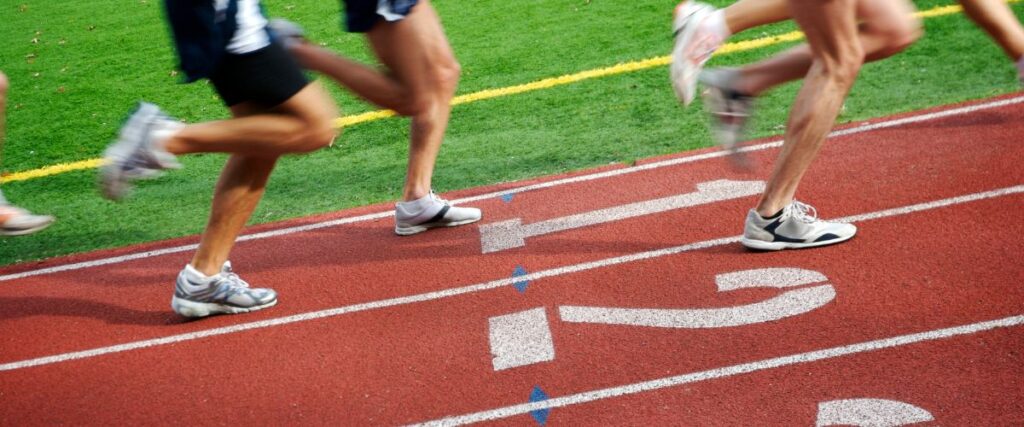 A group of runners on a race track.