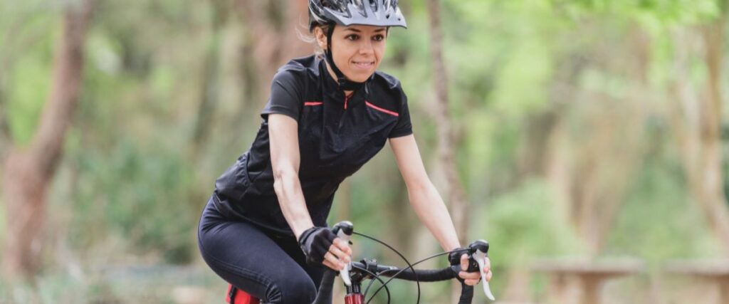 A female cyclists on the road. 