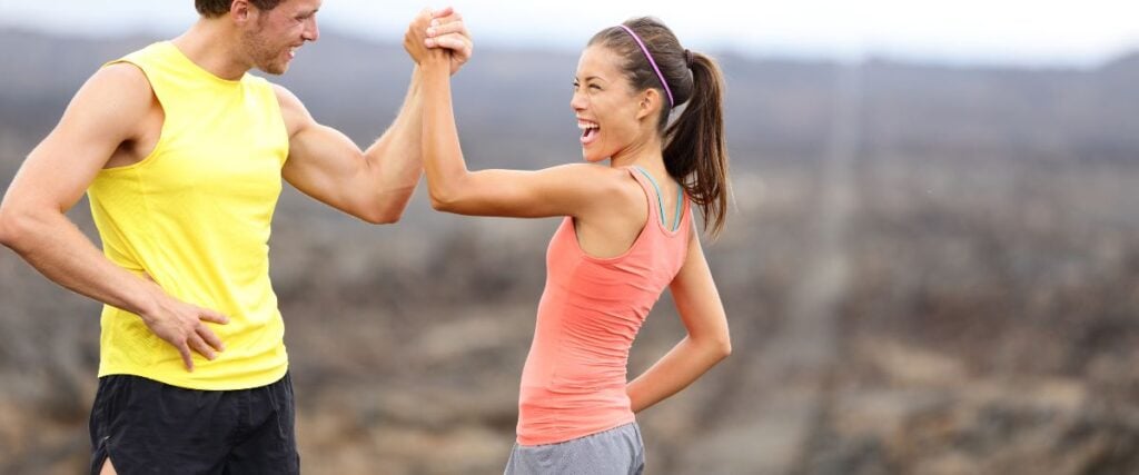 Two people high-fiving after their run. 