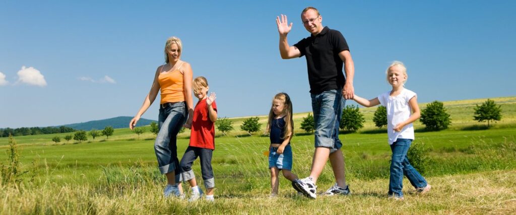 A family walking in a field together. 
