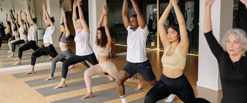 A group of people at a yoga studio doing yoga. 
