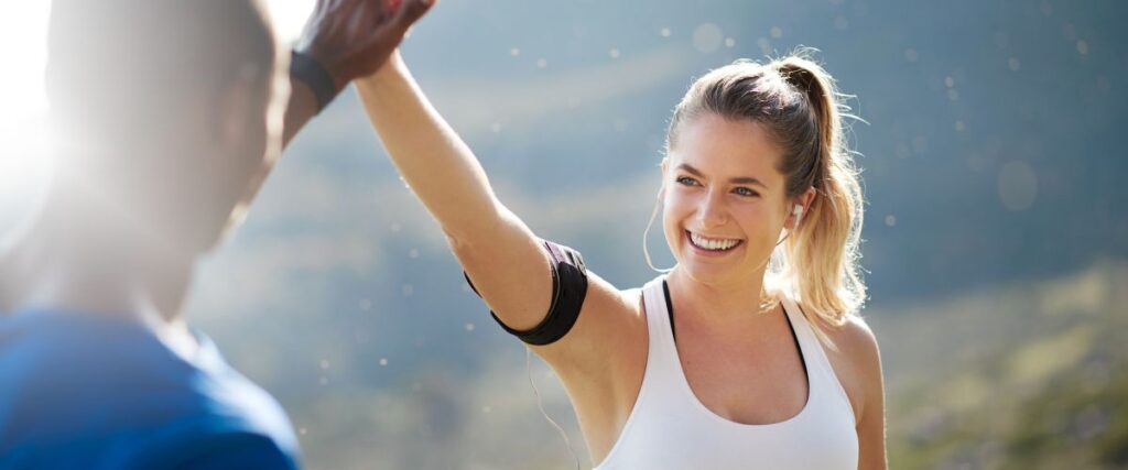 Two people high-fiving after their workout. 