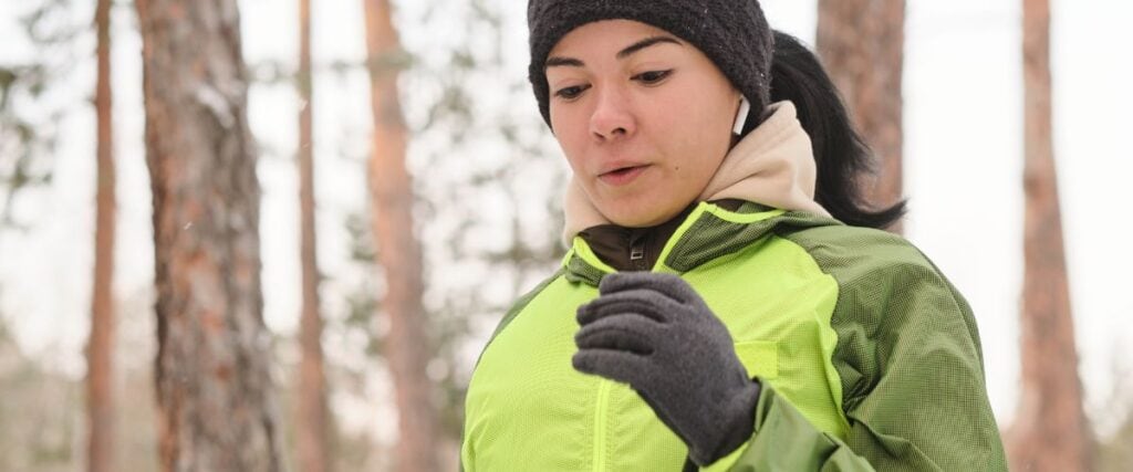 A woman dressed up while running in winter. 
