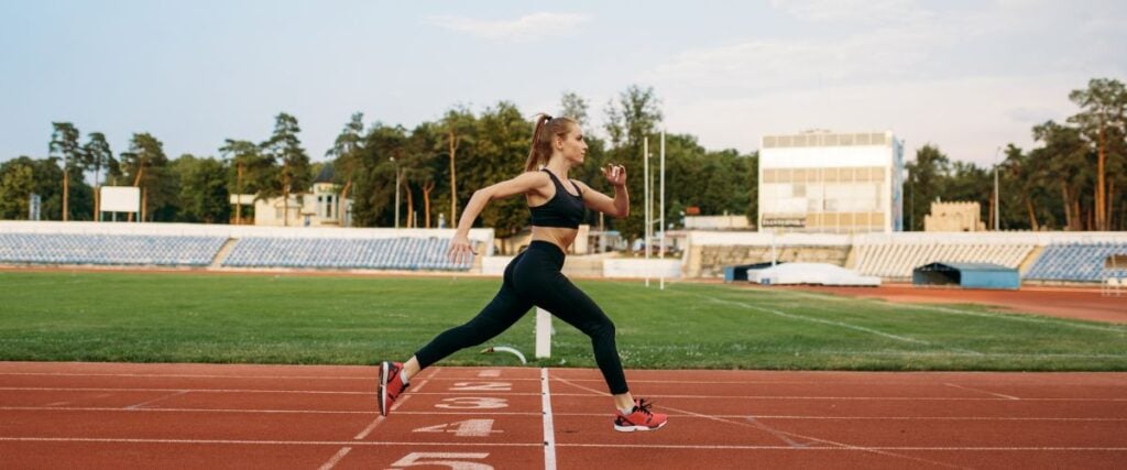 A female runner on a track field.